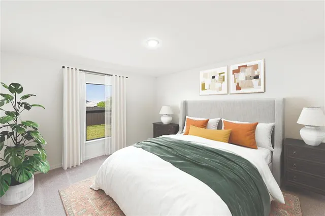 a bedroom with a large bed and a potted plant