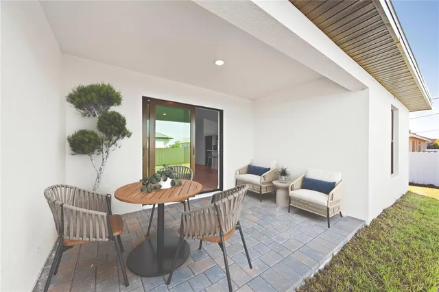 a dining room with furniture and potted plants