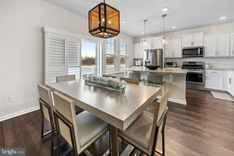 a view of a dining room with furniture wooden floor and chandelier