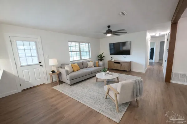a bedroom with a bed and a potted plant