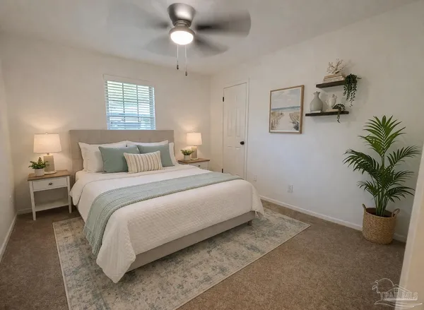 an empty room with windows and chandelier fan