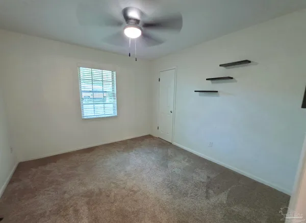 a bedroom with a bed and window
