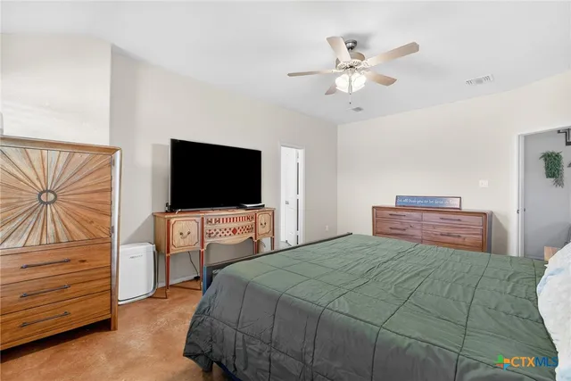 a bedroom with a bed and a flat screen tv