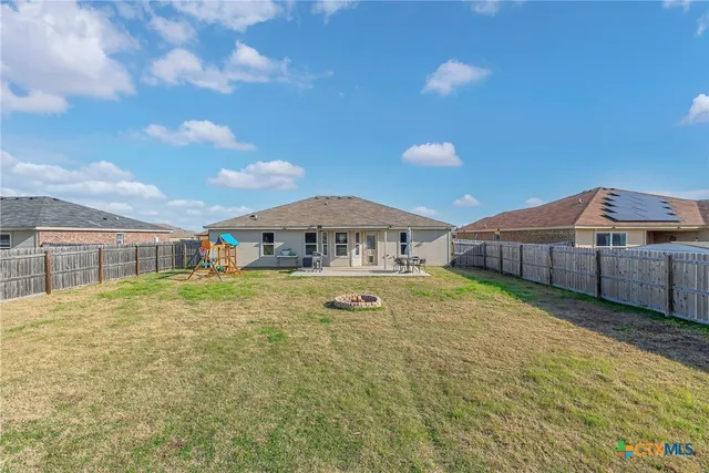 a front view of a house with yard swimming pool and outdoor seating