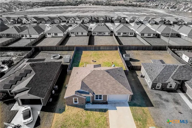 an aerial view of a house with a swimming pool