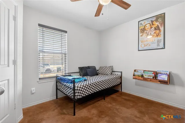 a bedroom with furniture and a window