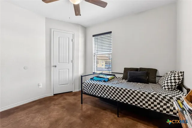 a bedroom with bed and window