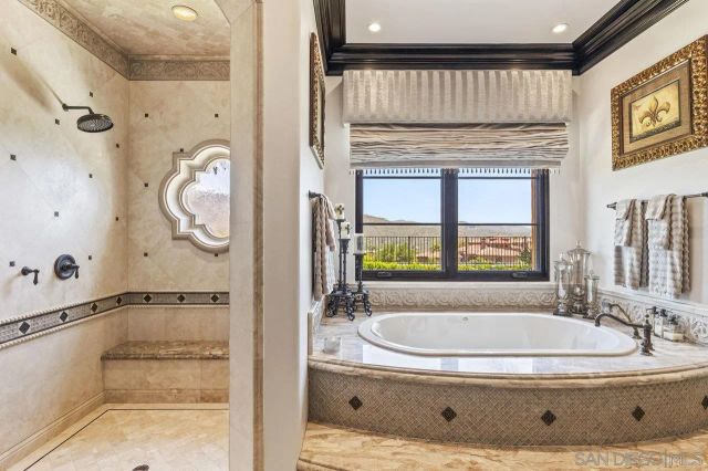 a vase of flowers sitting on a table with a potted plant