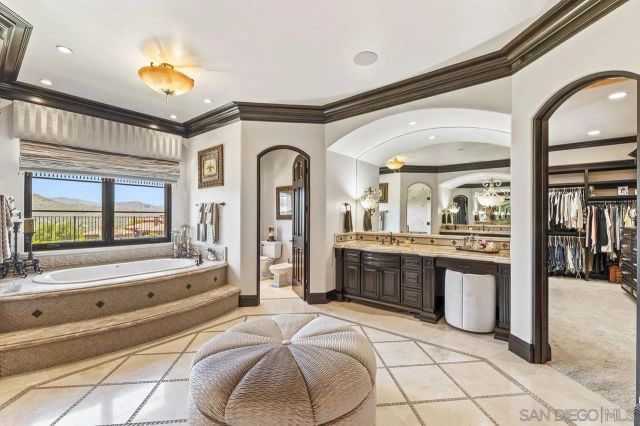 a living room with furniture and a mirror