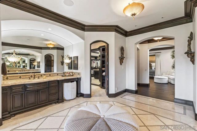 a view of a dining room with furniture a chandelier and wooden floor