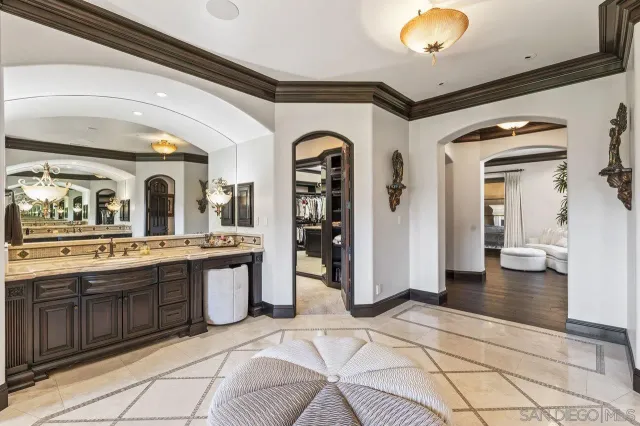 a view of a dining room with furniture a chandelier and wooden floor