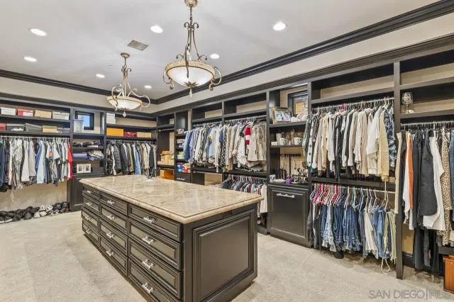 a bedroom with furniture and a large window