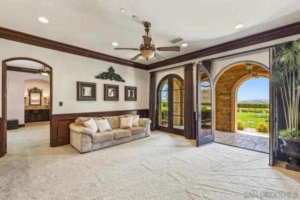 a living room with furniture and a chandelier