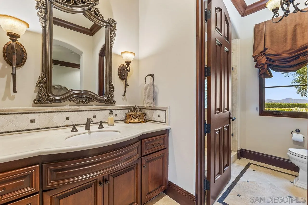 14170 Bryce Point Poway, CA 92064 - Photo 44 of 67 a bathroom with a sink and a mirror
