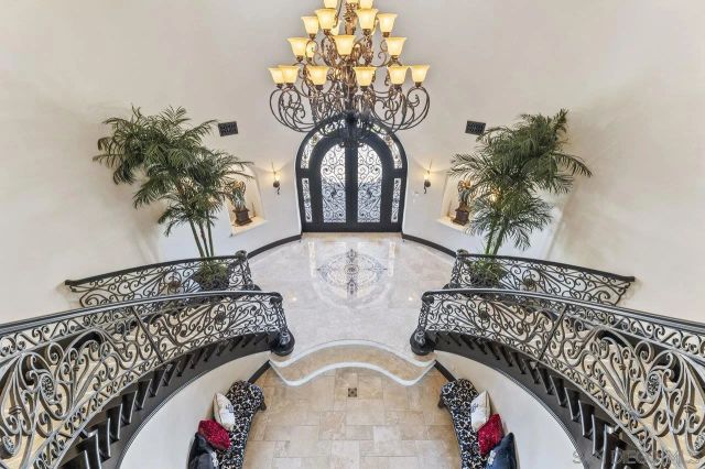 a view of swimming pool with outdoor seating and house in the background