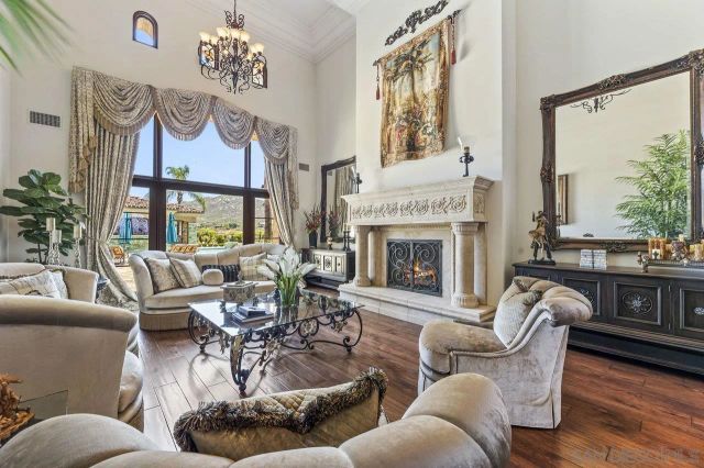 a living room with furniture large window and a fireplace