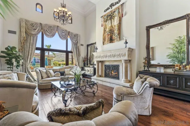 a living room with furniture large window and a fireplace