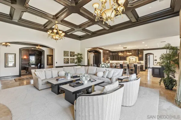 a living room with furniture and a chandelier