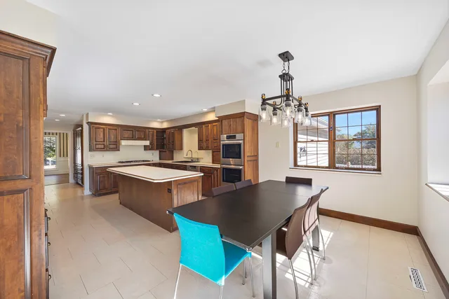 a kitchen with stainless steel appliances granite countertop a refrigerator and a sink