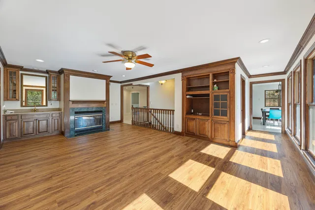 a view of a a dining room with furniture window and wooden floor
