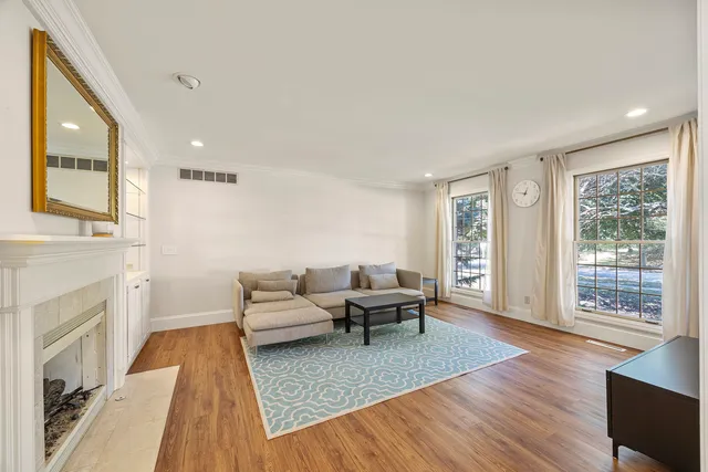 a bathroom with a tub a double vanity sink and a mirror