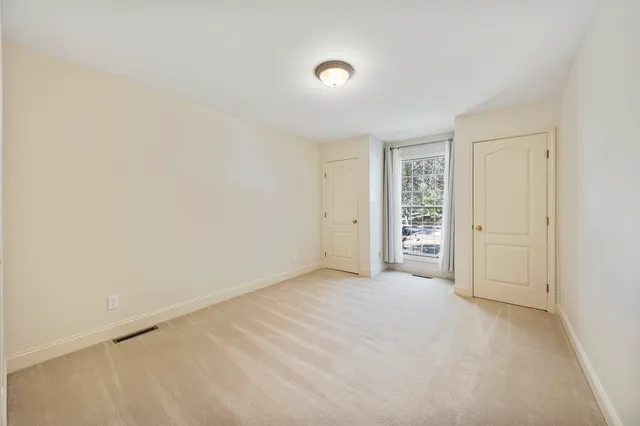 a view of a livingroom with a ceiling fan and window