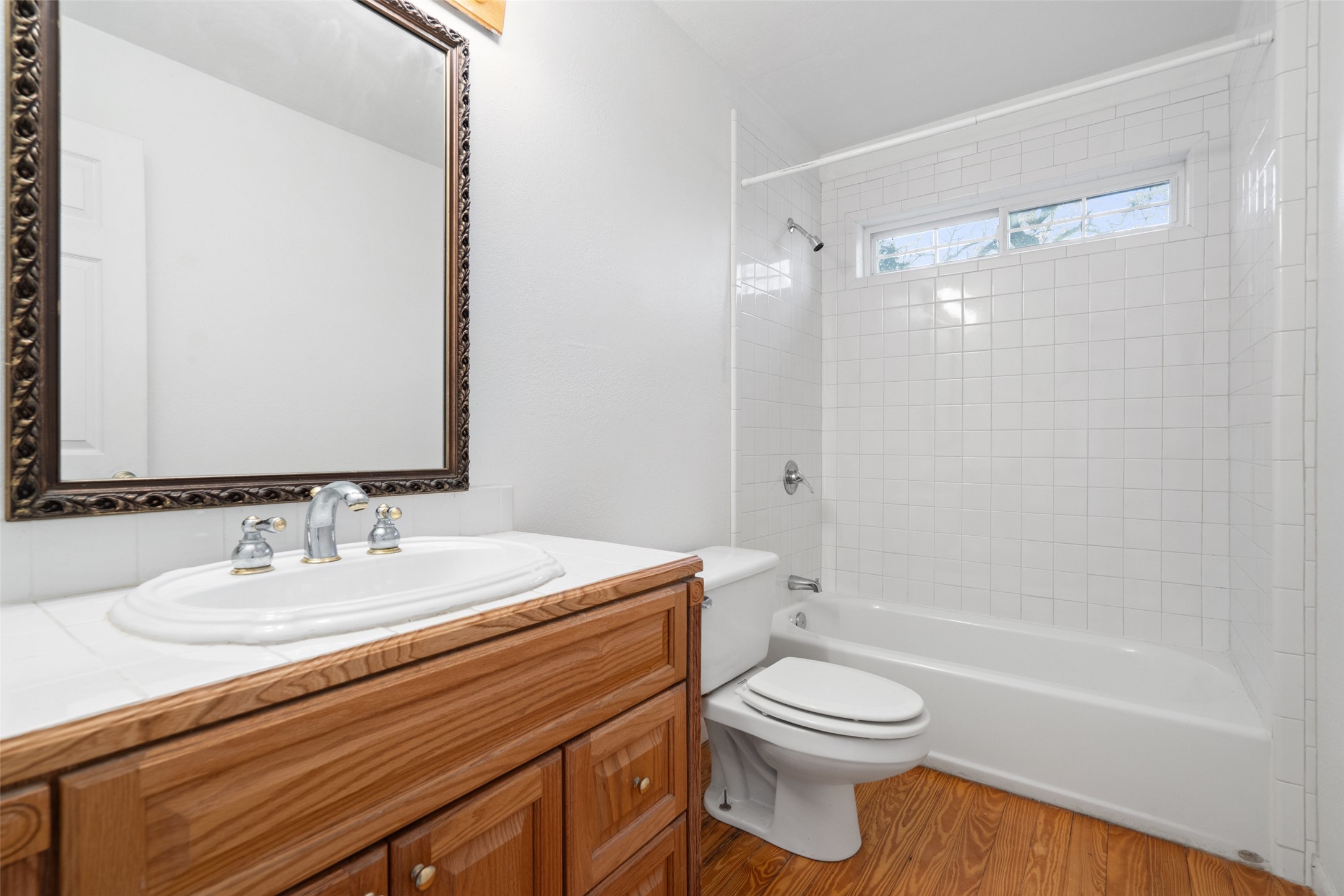 1401 Pursley Road Dripping Springs, TX 78620 - Photo 16 of 35 Full bathroom with vanity, shower combination, and light wood finished floors