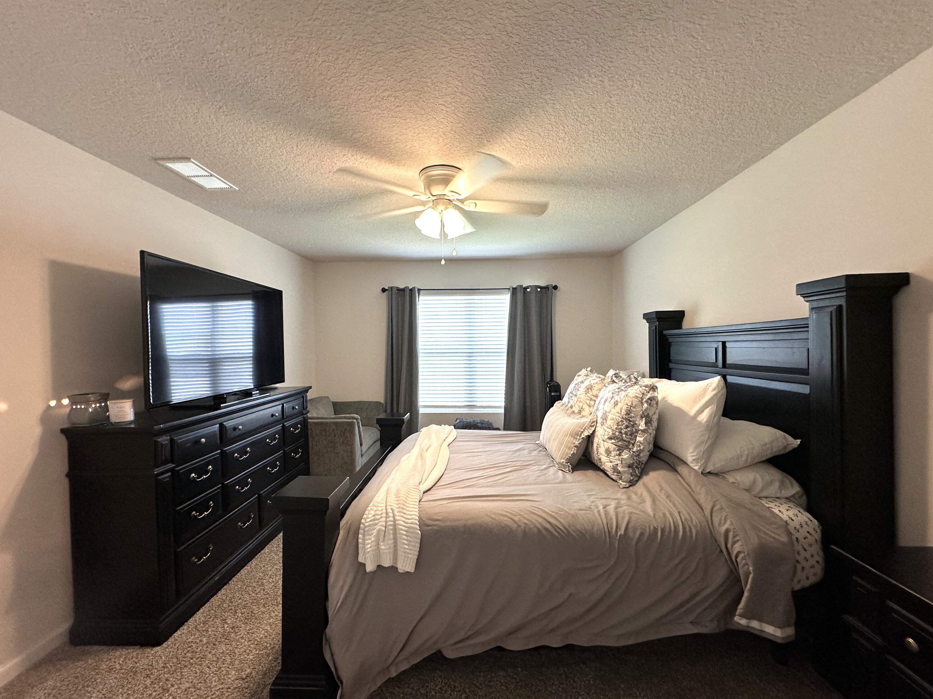 828 Otto Loop Crestview, FL 32539 - Photo 13 of 30 a bedroom with a bed and a flat screen tv