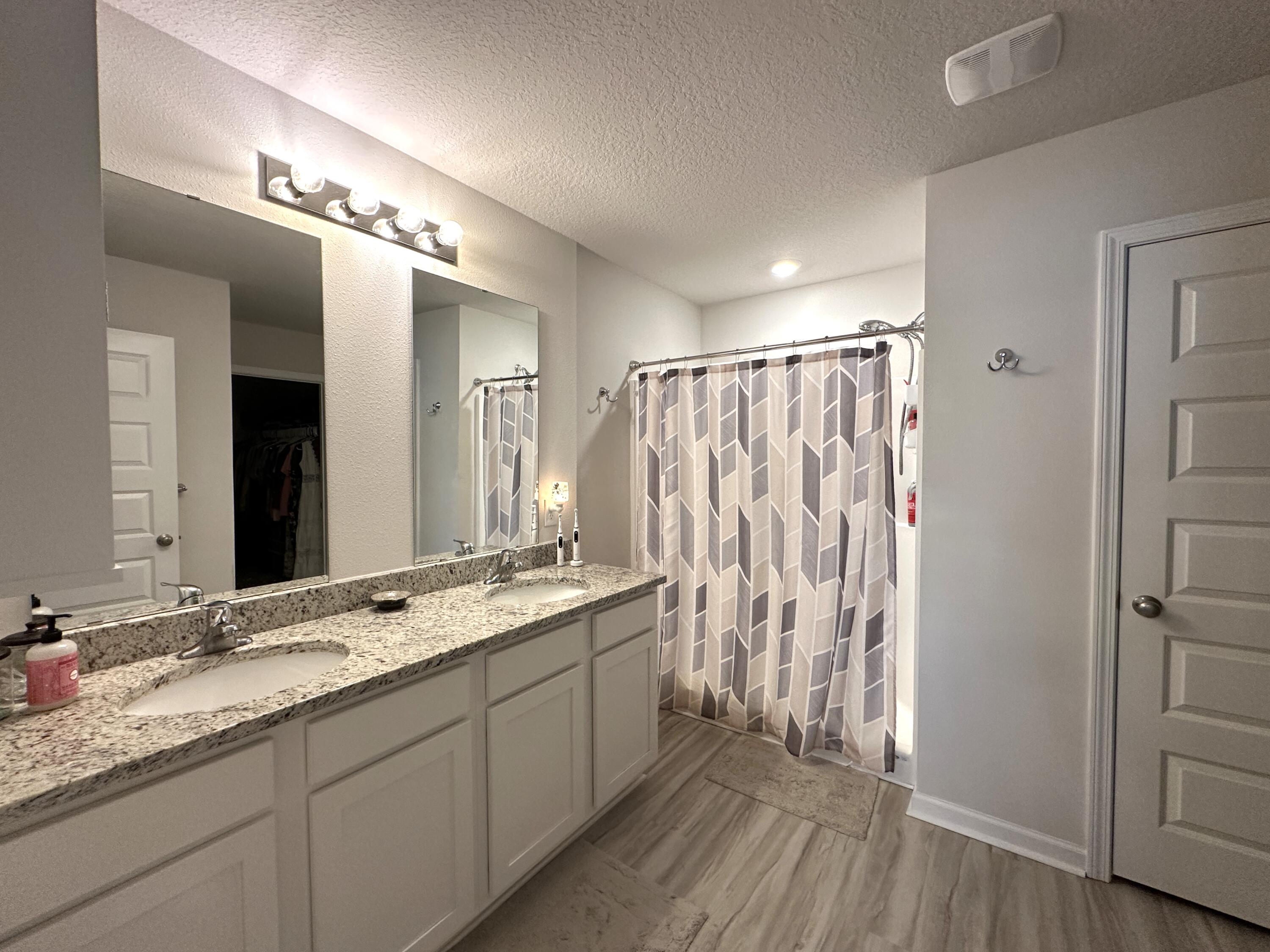 828 Otto Loop Crestview, FL 32539 - Photo 15 of 30 a bathroom with a double vanity sink and mirror