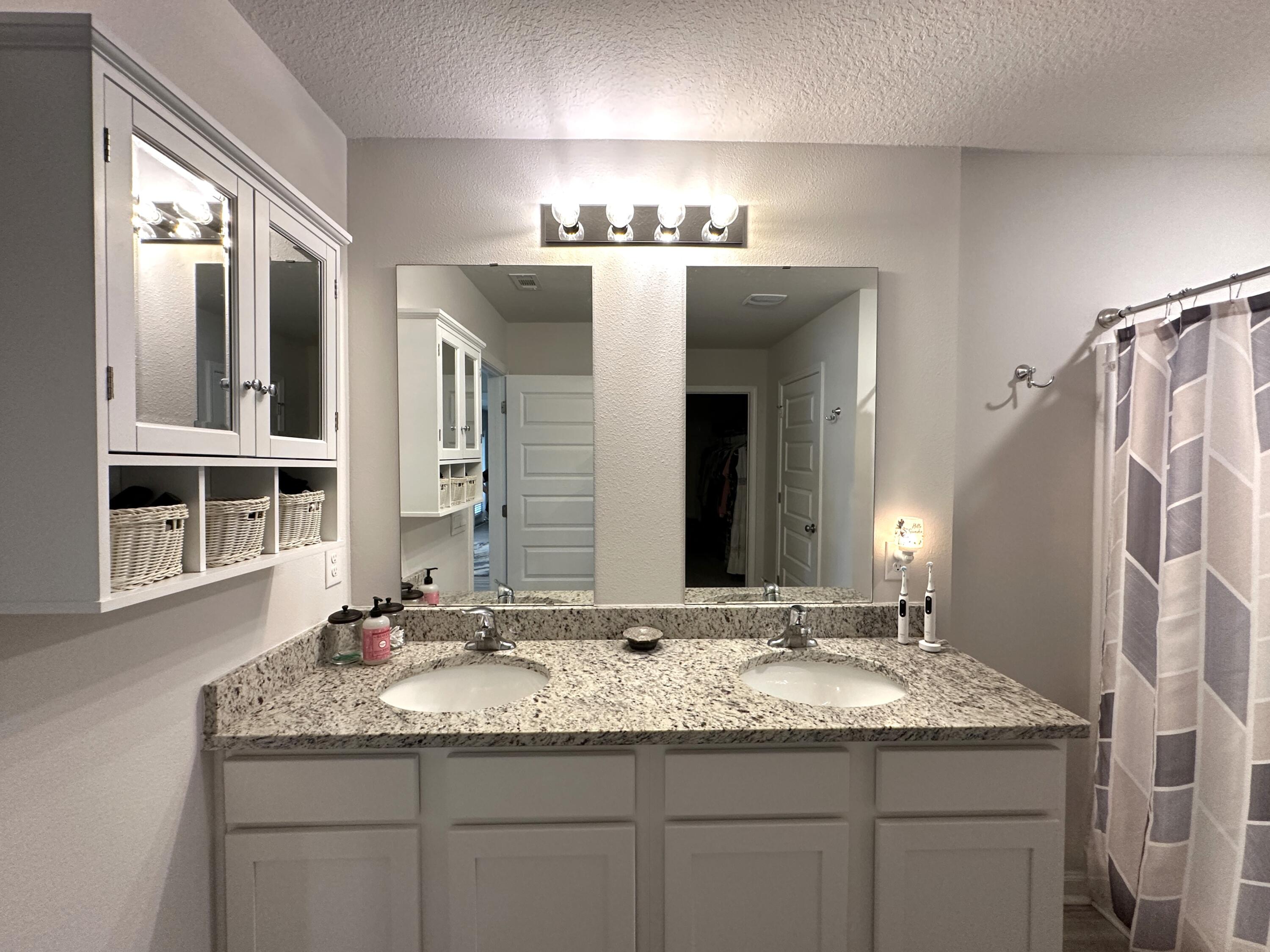 828 Otto Loop Crestview, FL 32539 - Photo 16 of 30 a bathroom with a granite countertop sink and a mirror