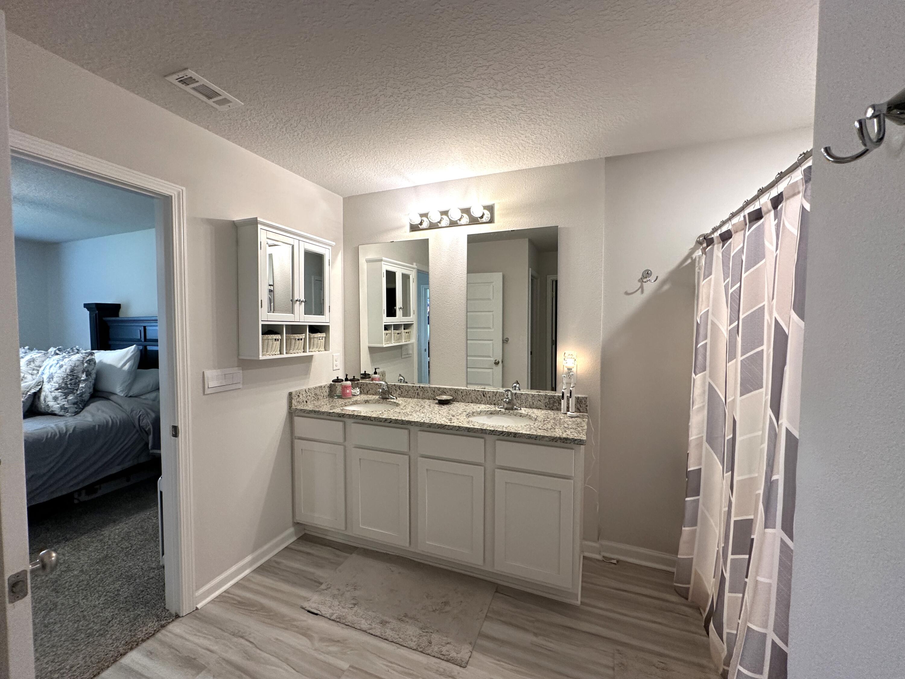 828 Otto Loop Crestview, FL 32539 - Photo 17 of 30 a bathroom with a double vanity sink and mirror