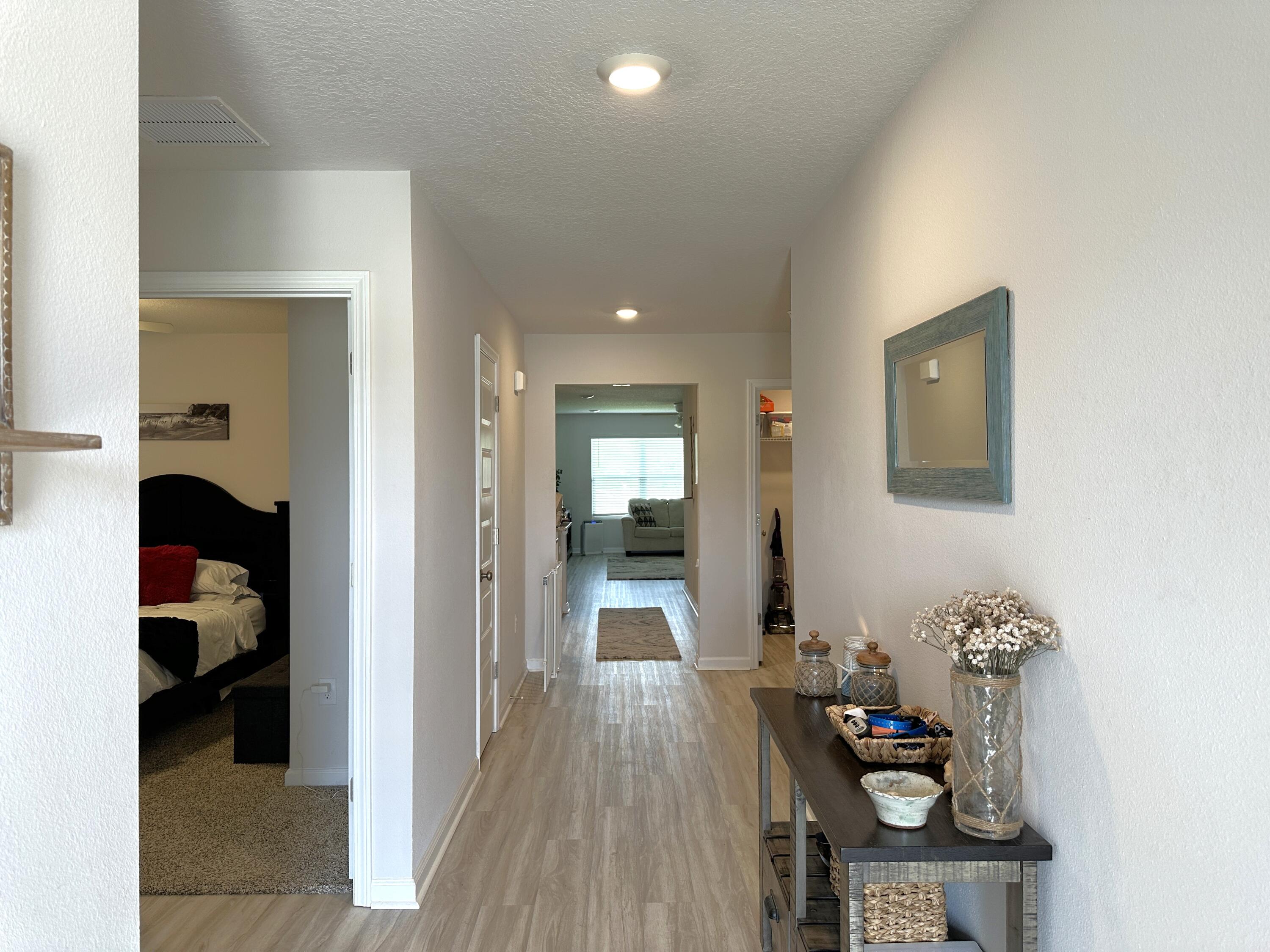 828 Otto Loop Crestview, FL 32539 - Photo 2 of 30 a hallway with a view of bedroom with wooden flooring