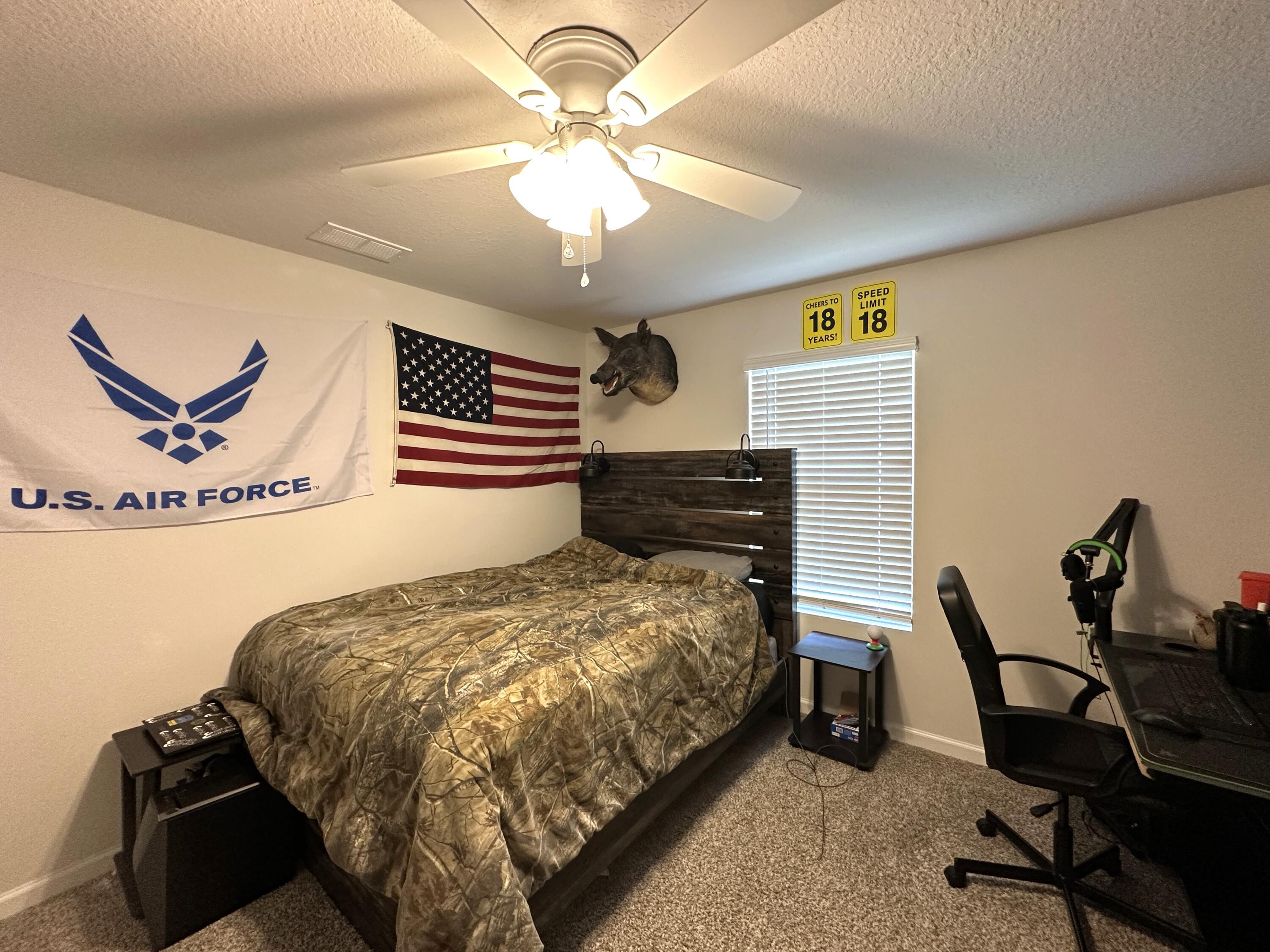 828 Otto Loop Crestview, FL 32539 - Photo 23 of 30 a bed room with a bed and a chair