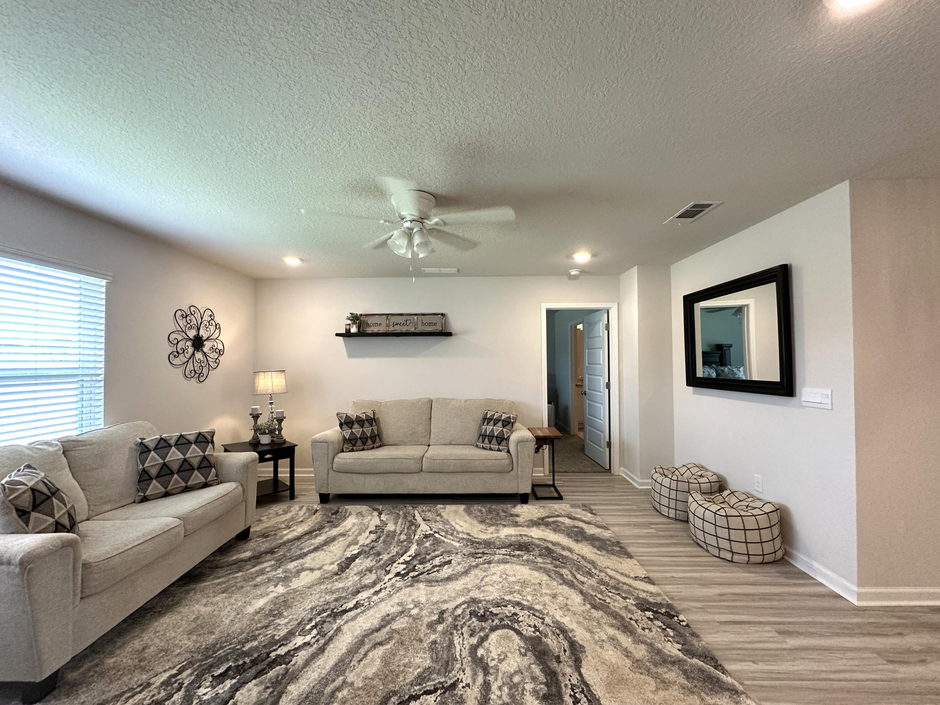 828 Otto Loop Crestview, FL 32539 - Photo 4 of 30 a bedroom with furniture and a couch