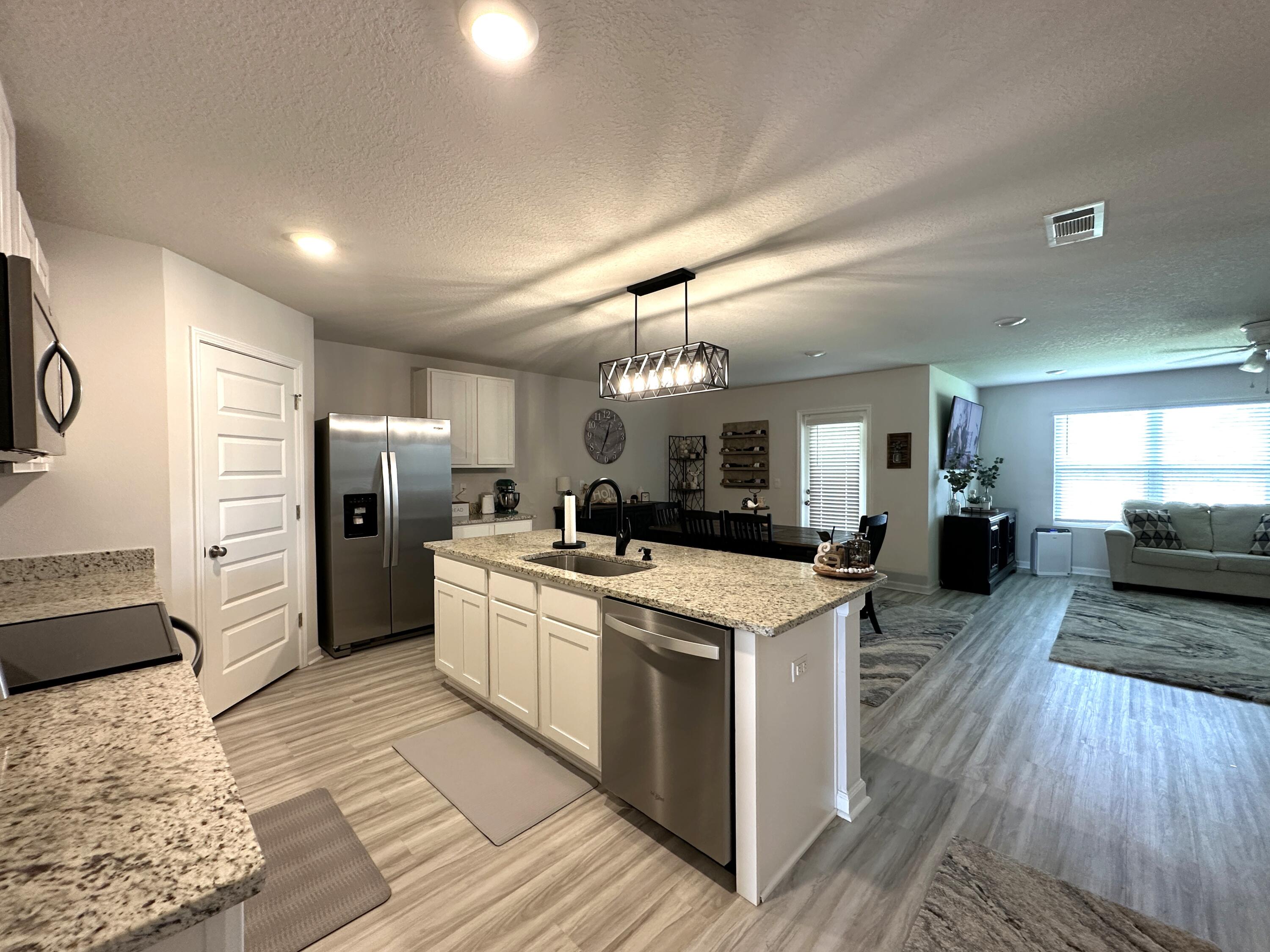 828 Otto Loop Crestview, FL 32539 - Photo 7 of 30 a kitchen that has a lot of white cabinets and stainless steel appliances