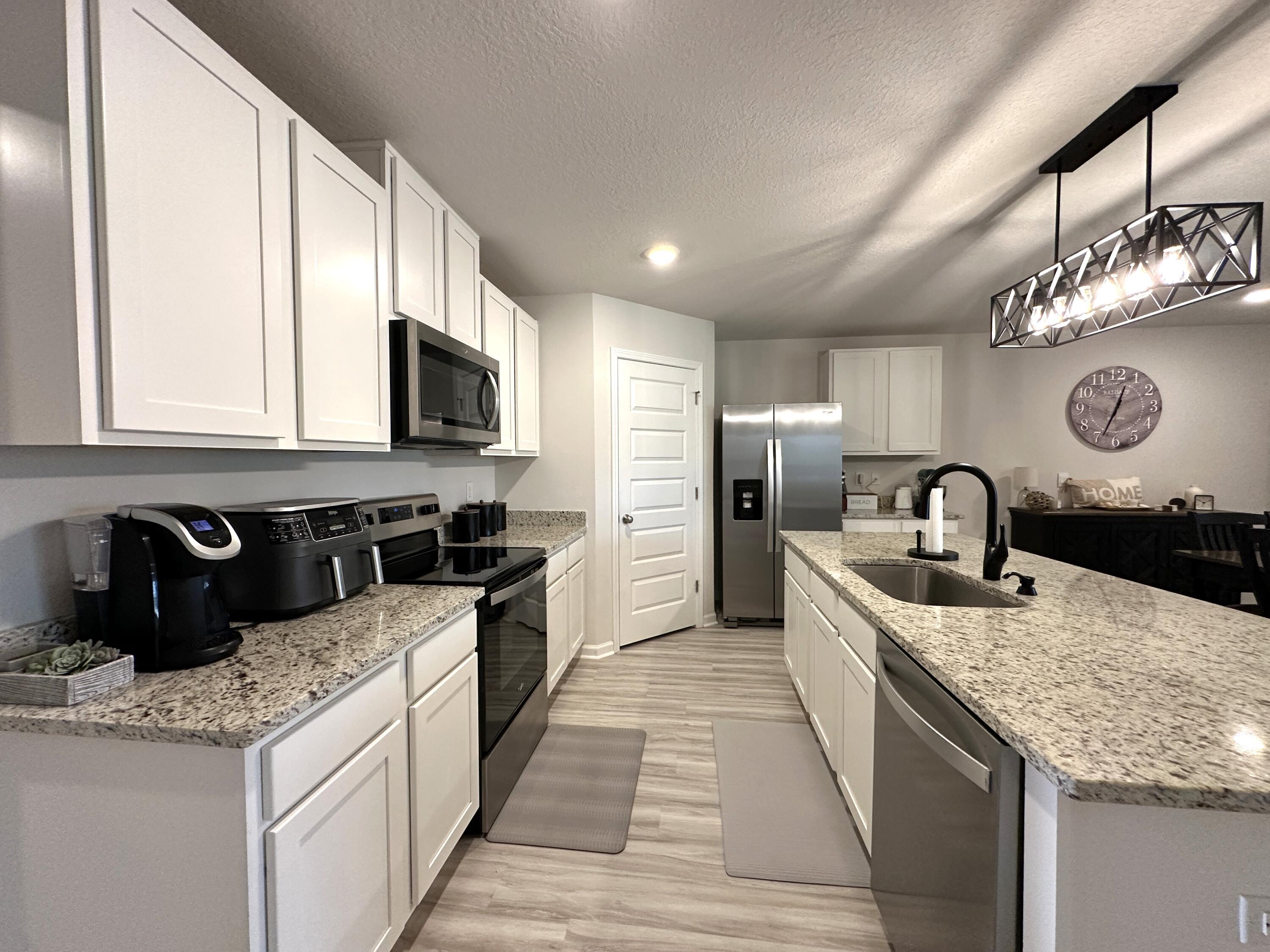 828 Otto Loop Crestview, FL 32539 - Photo 10 of 30 a kitchen with stainless steel appliances granite countertop a sink stove and refrigerator