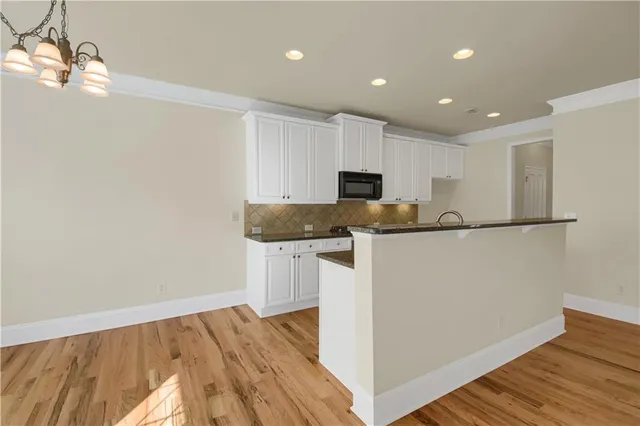 a kitchen with stainless steel appliances granite countertop a refrigerator sink and microwave