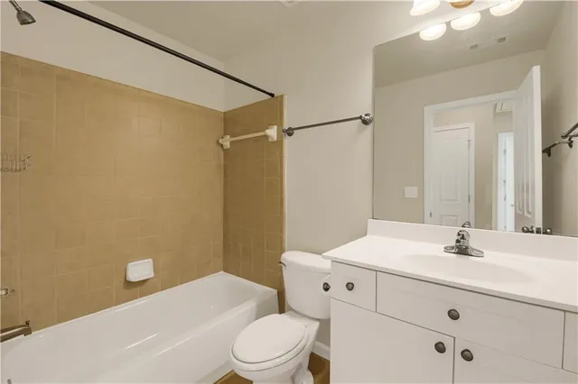 a bathroom with a sink a mirror and a toilet