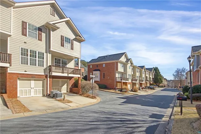 a view of a brick house with many windows