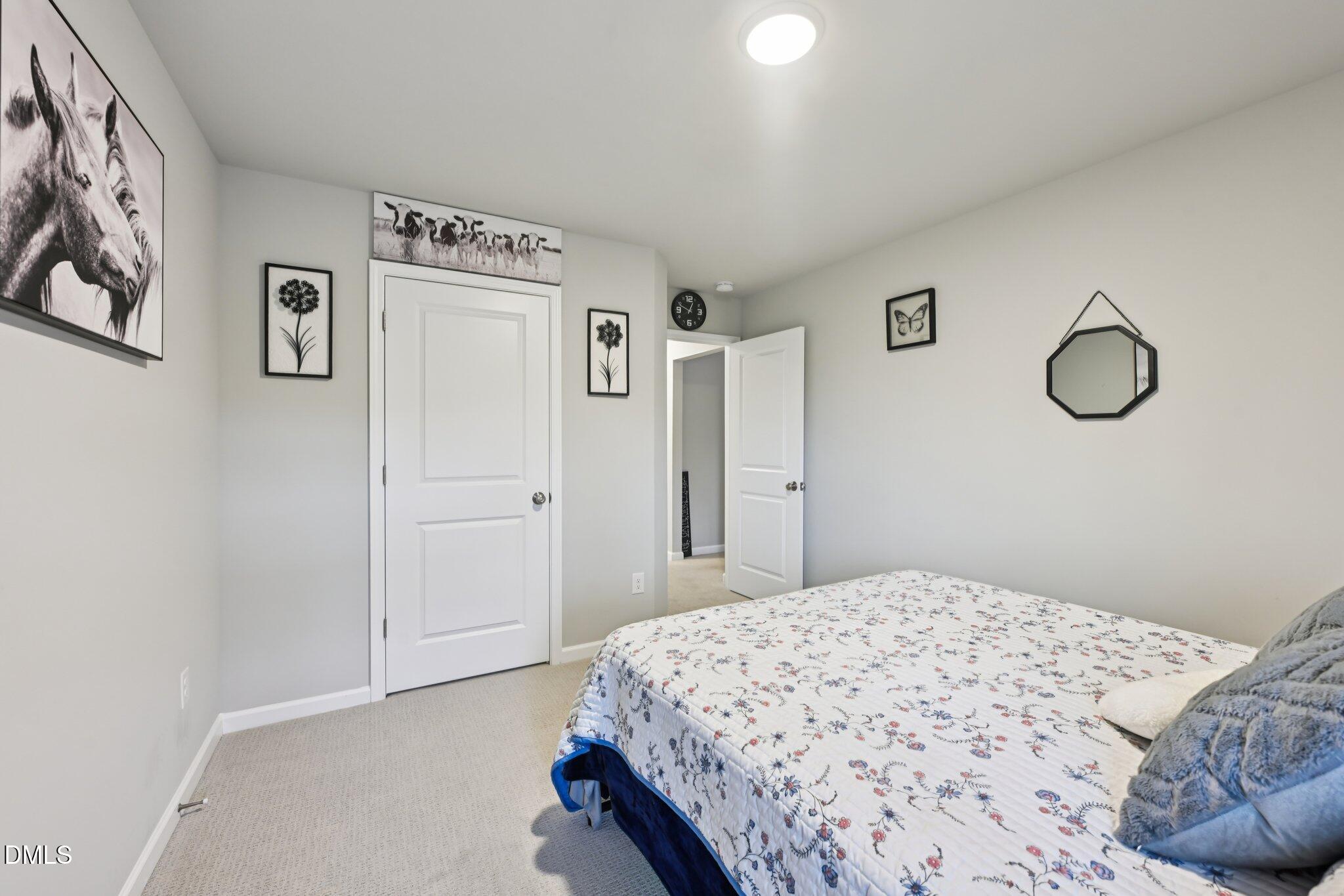391 Byrdtown Road Benson, NC 27504 - Photo 17 of 28 a bedroom with a bed and cabinets