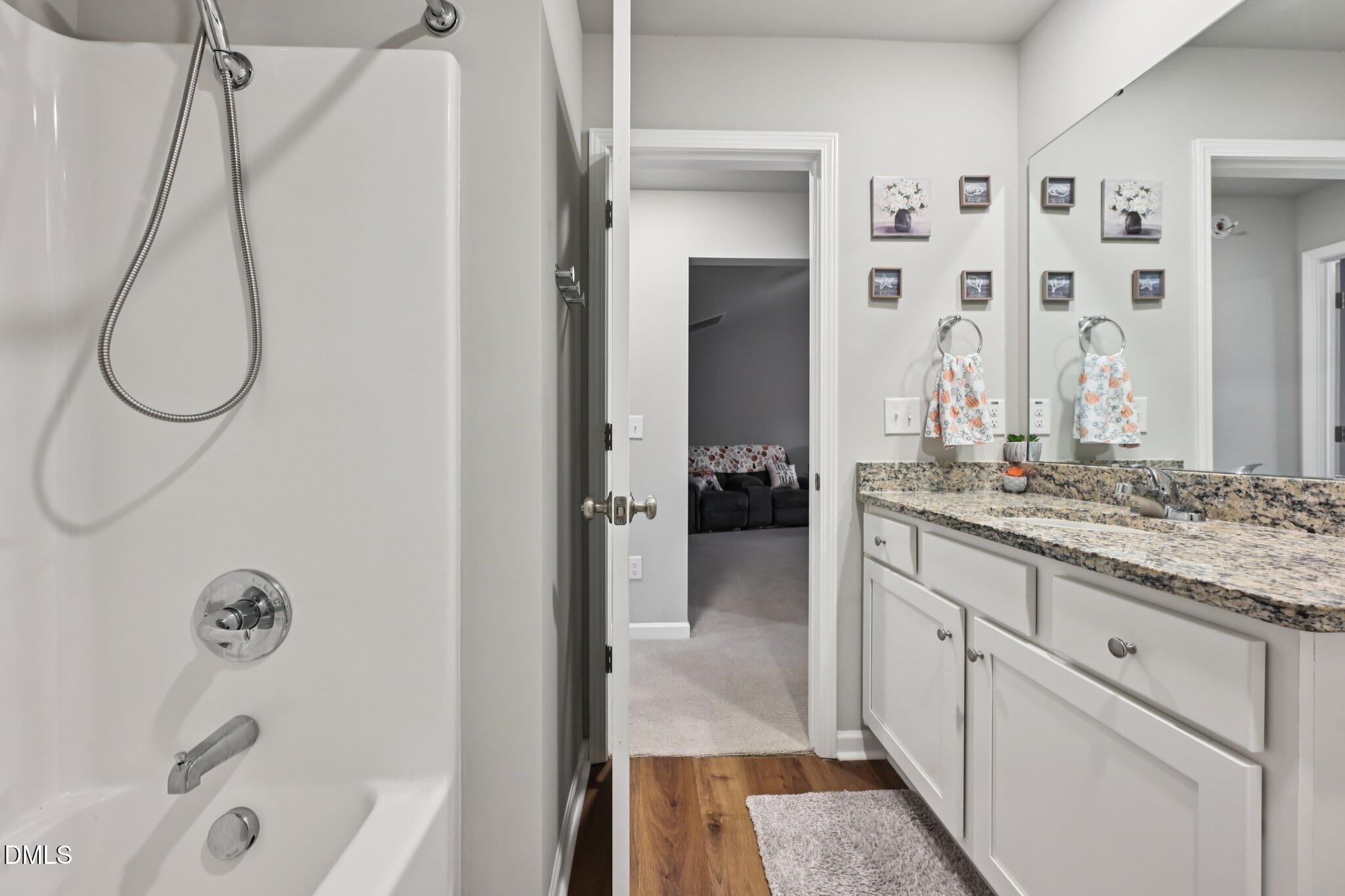 391 Byrdtown Road Benson, NC 27504 - Photo 19 of 28 a bathroom with a granite countertop sink and a mirror
