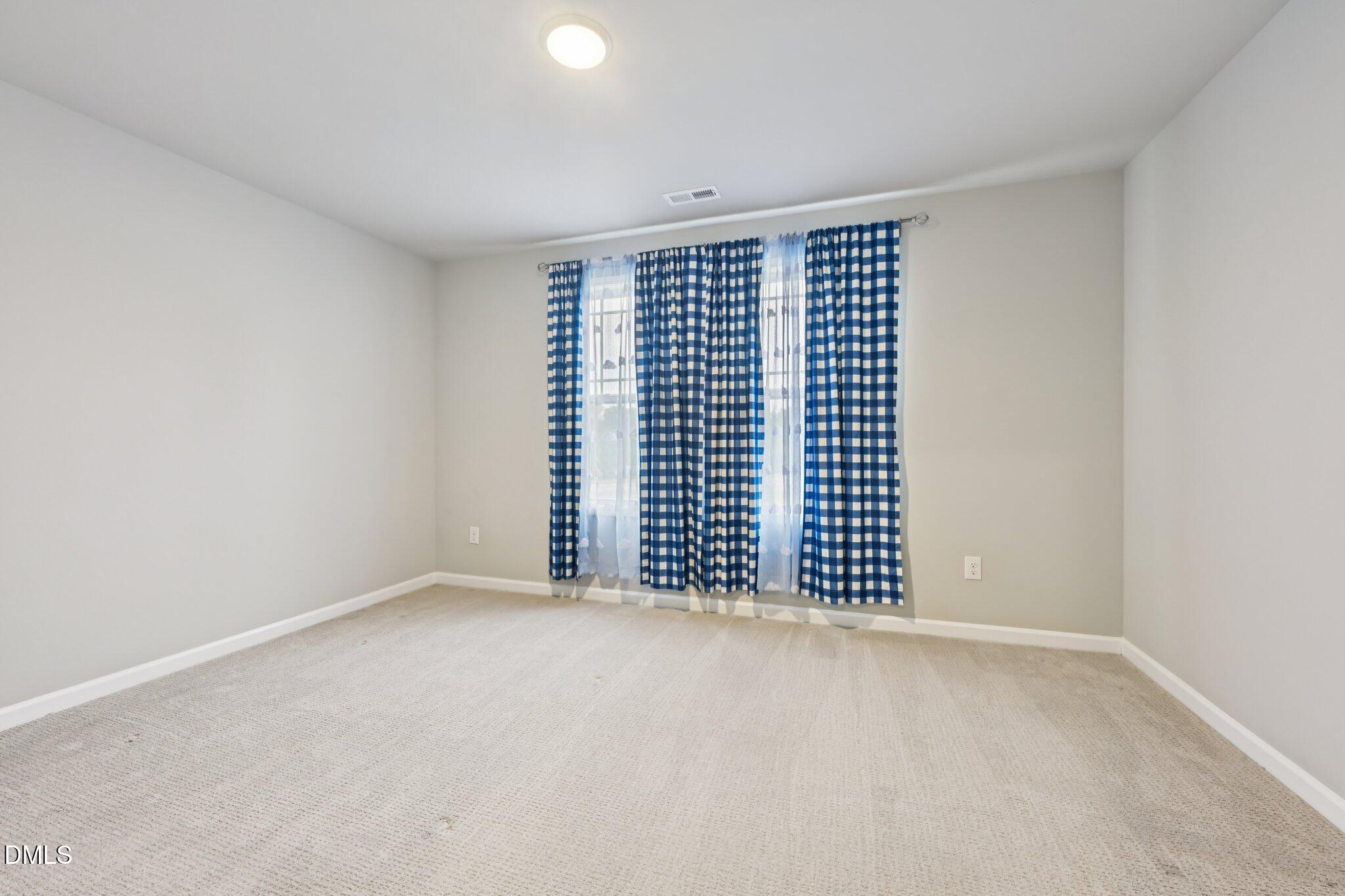 391 Byrdtown Road Benson, NC 27504 - Photo 20 of 28 a view of an empty room with a window