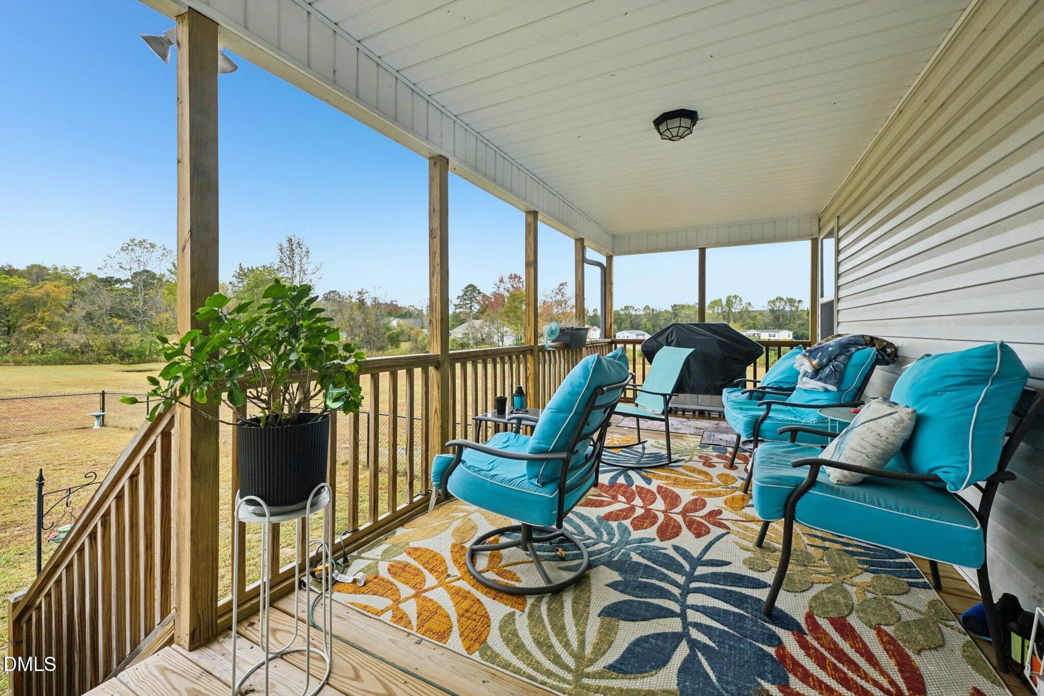 391 Byrdtown Road Benson, NC 27504 - Photo 22 of 28 a view of a balcony with chairs