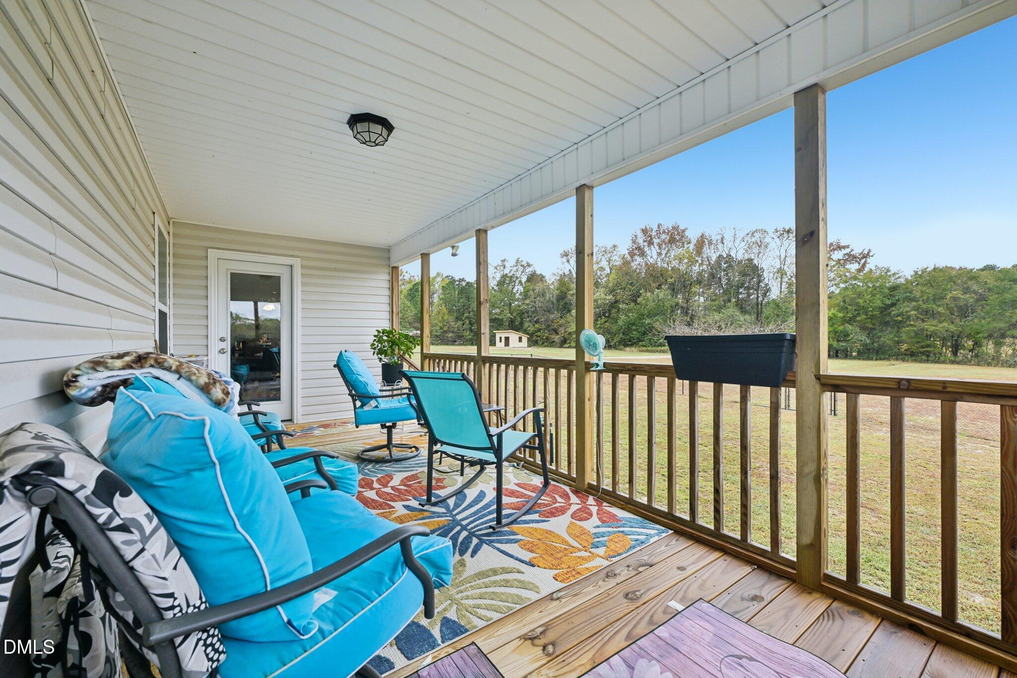 391 Byrdtown Road Benson, NC 27504 - Photo 23 of 28 a balcony with chairs and a table