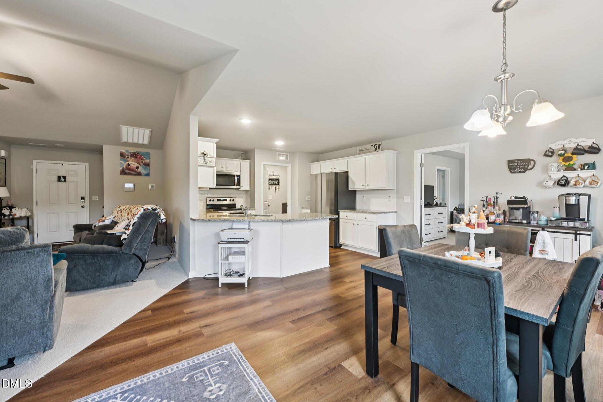 391 Byrdtown Road Benson, NC 27504 - Photo 7 of 28 a living room with kitchen island furniture and a chandelier