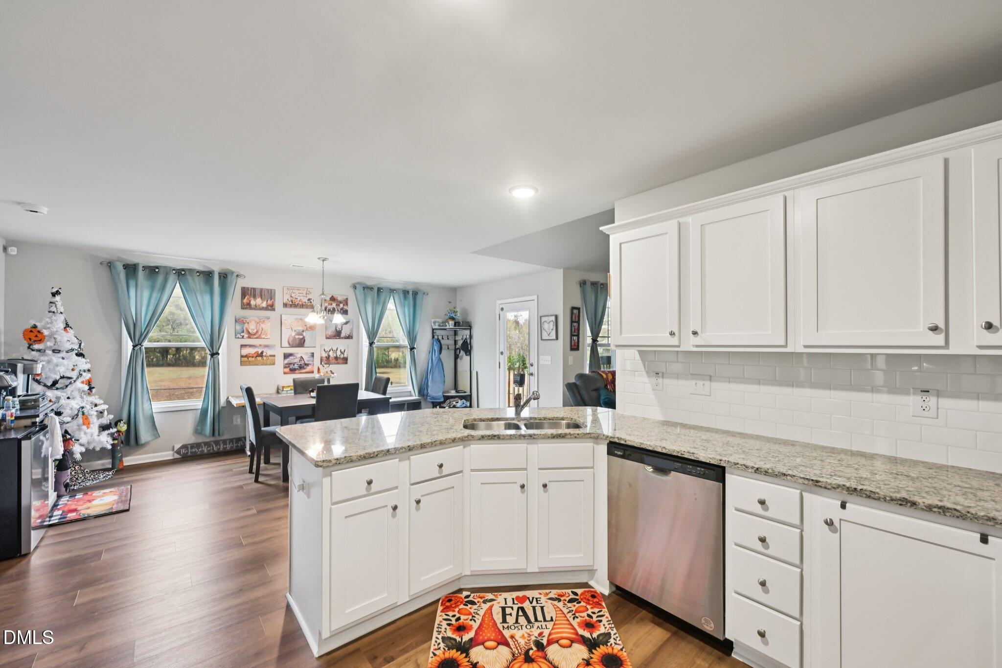 391 Byrdtown Road Benson, NC 27504 - Photo 9 of 28 a kitchen with granite countertop a sink stove and cabinets