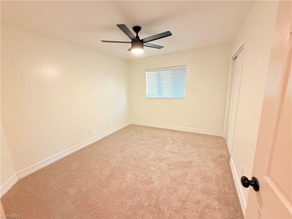 9017 Pineapple Road Fort Myers, FL 33967 - Photo 14 of 24 Unfurnished bedroom featuring light colored carpet, a ceiling fan, and a closet