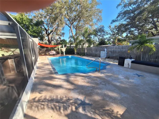 a view of backyard with outdoor seating and trees