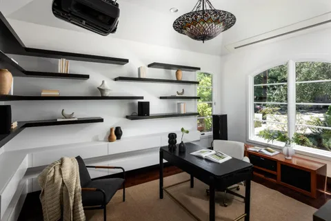 a living room with furniture and a floor to ceiling window