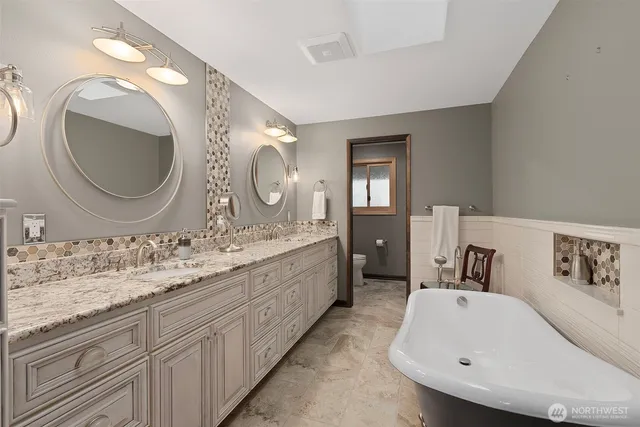 a bathroom with a double vanity sink and a mirror
